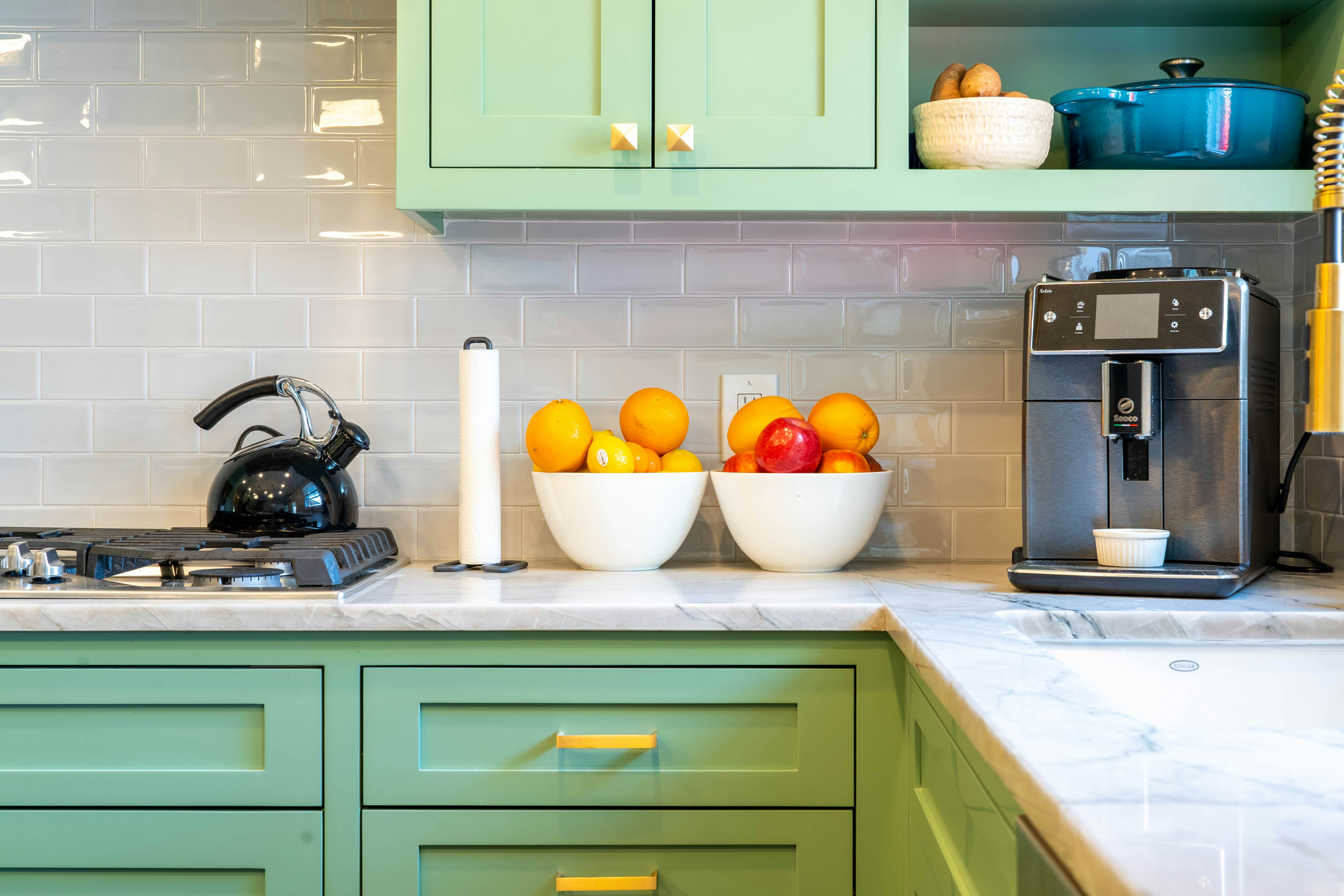 Quartzite kitchen countertops with green cabinetry